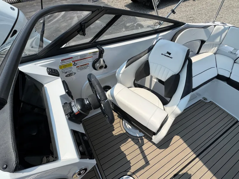 Slide: The Image of 2025 Stingray 211 DC boat interior with steering wheel and comfortable seating. - 9