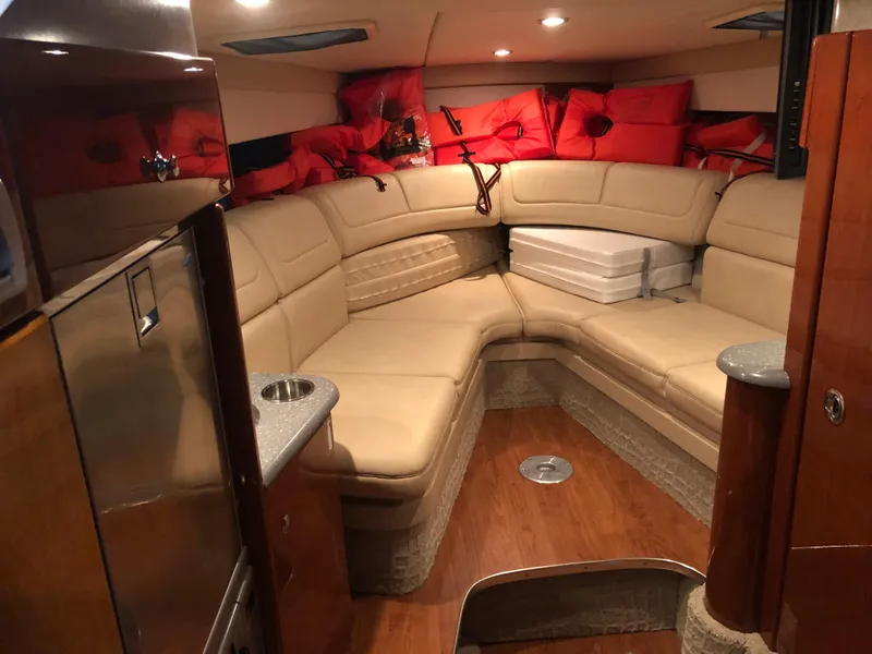 Slide: The Image of 2008 Formula 310 Sun Sport cabin with beige seating and red life jackets. - 12