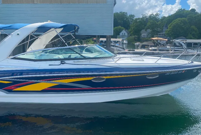 Slide: The Image of 2008 Formula 310 Sun Sport boat docked, featuring sleek design and vibrant graphics. - 2