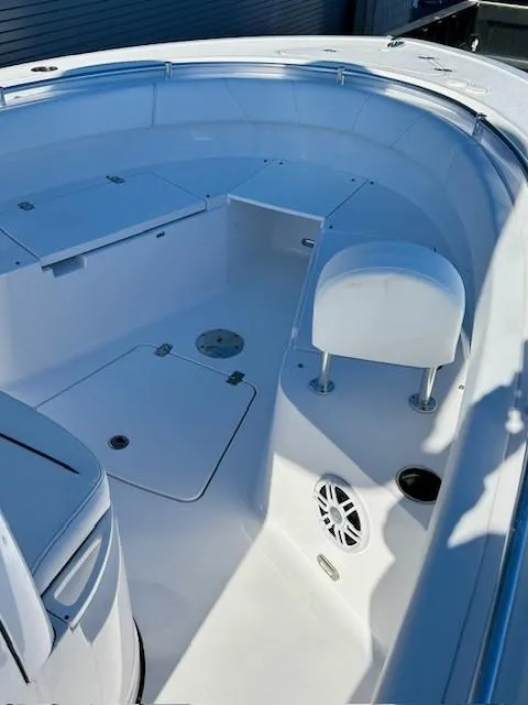 Slide: The Image of 2024 Sportsman Open 232 Center Console boat interior, featuring seating and storage compartments. - 14