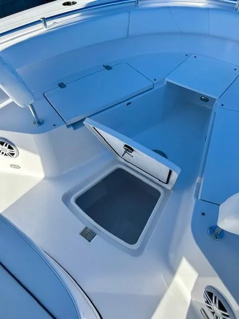 Slide: The Image of 2024 Sportsman Open 232 Center Console boat interior with storage compartments. - 18