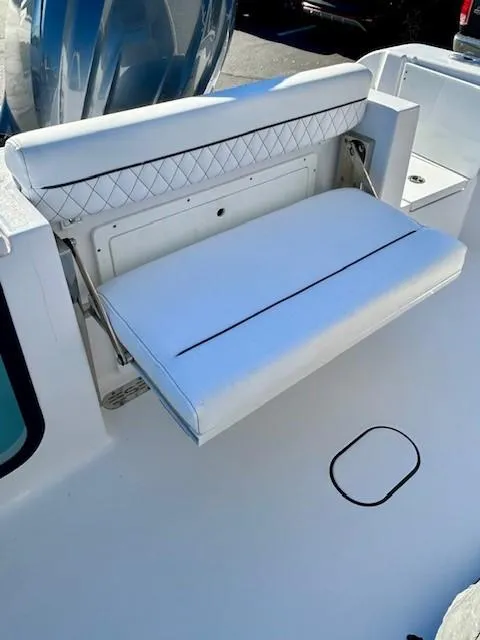 Slide: The Image of 2024 Sportsman Open 232 Center Console boat with foldable white seat. - 20