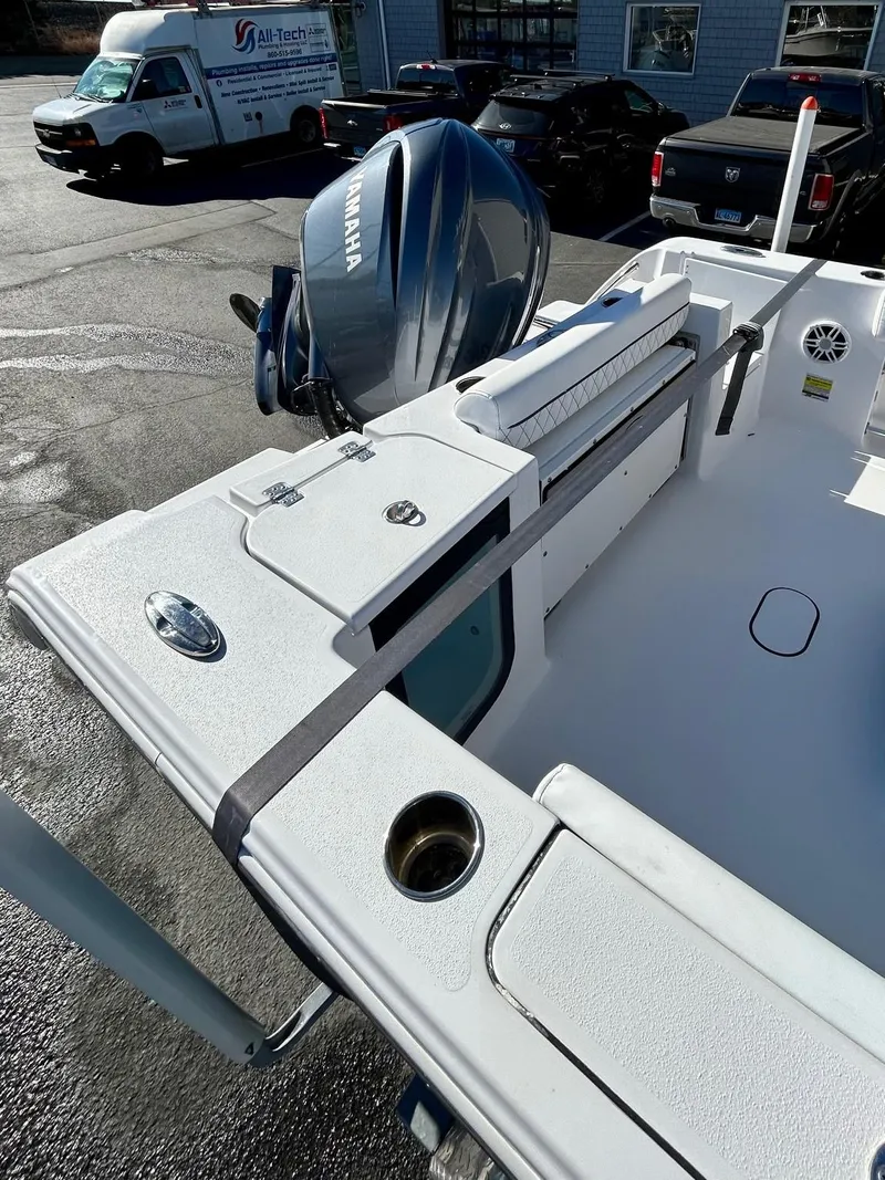 Slide: The Image of 2024 Sportsman Open 232 Center Console boat with Yamaha engine, parked outdoors. - 21
