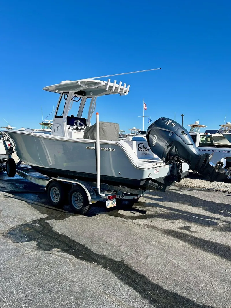 Slide: The Image of 2024 Sportsman Open 232 Center Console boat on trailer, parked outdoors. - 3