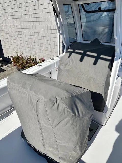 Slide: The Image of 2024 Sportsman Open 232 Center Console boat with covered seats, outdoor setting. - 8