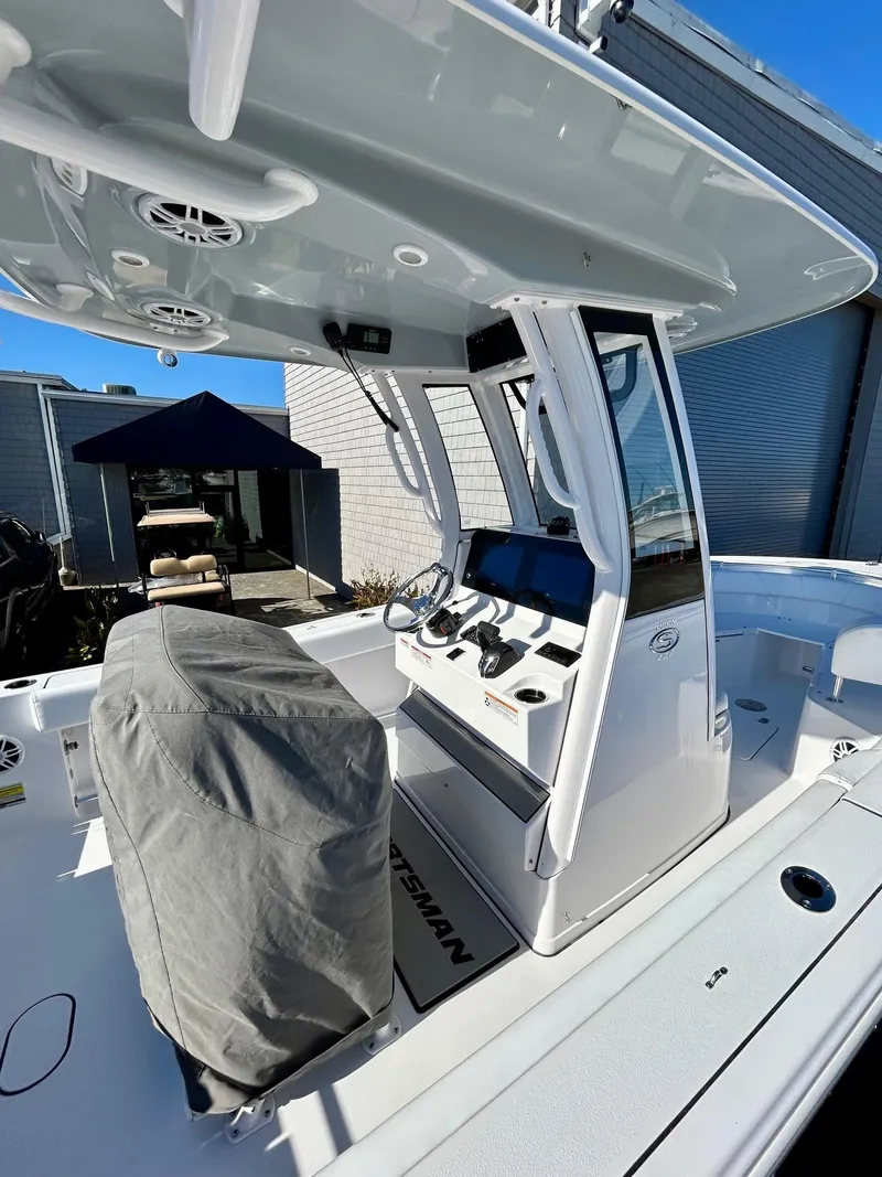 Slide: The Image of 2024 Sportsman Open 232 Center Console boat with modern helm and covered seating. - 9