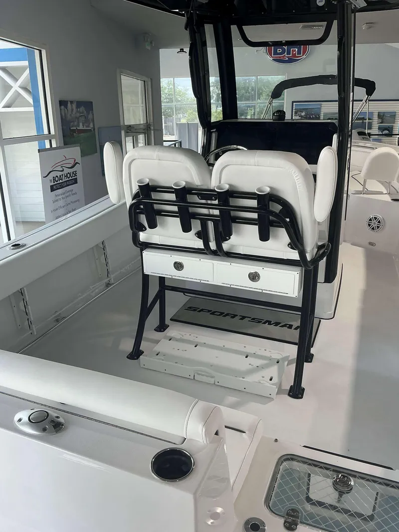 Slide: The Image of 2025 Sportsman 231 Heritage boat interior with white seating and storage compartments. - 10
