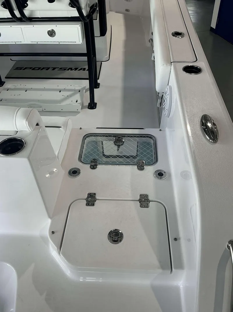 Slide: The Image of 2025 Sportsman 231 Heritage boat interior with storage compartments and seating. - 12