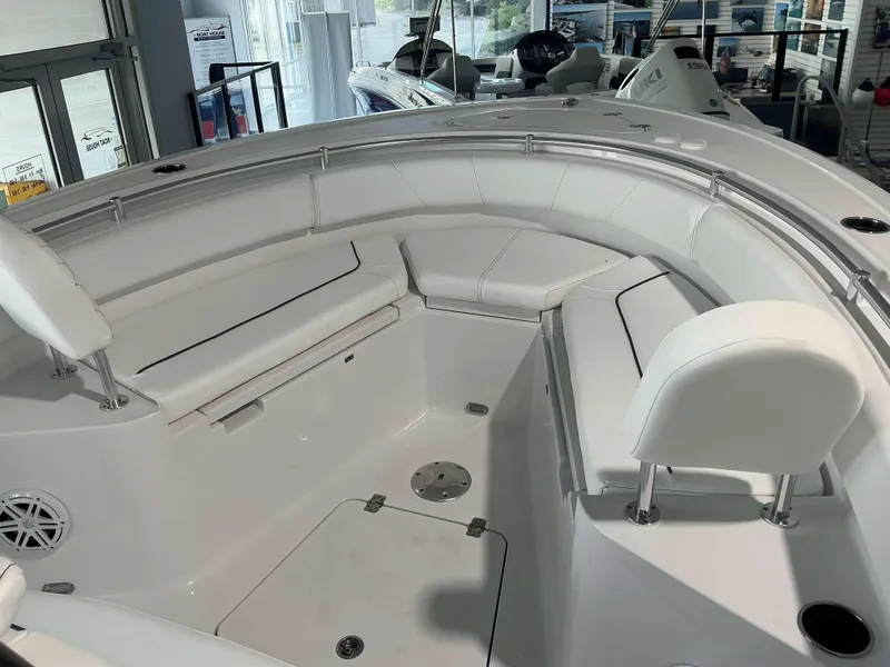 Slide: The Image of 2025 Sportsman 231 Heritage boat interior with white seating and modern design. - 14