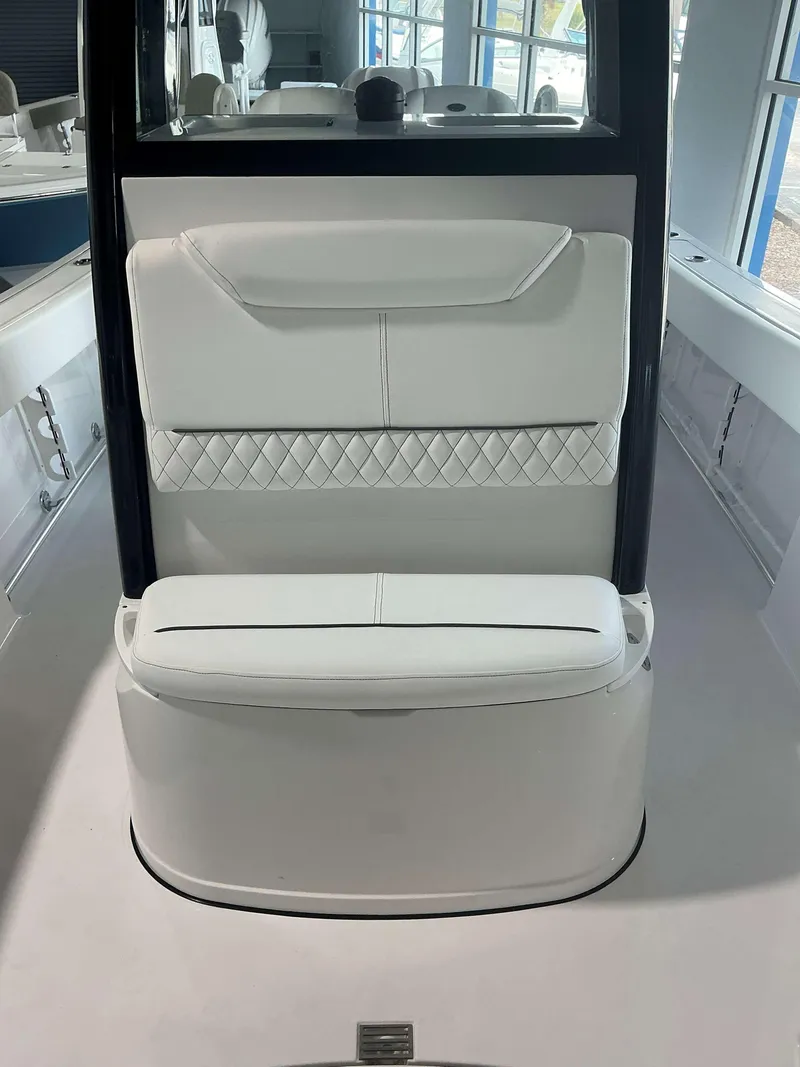 Slide: The Image of 2025 Sportsman 231 Heritage boat interior with white cushioned seating. - 16