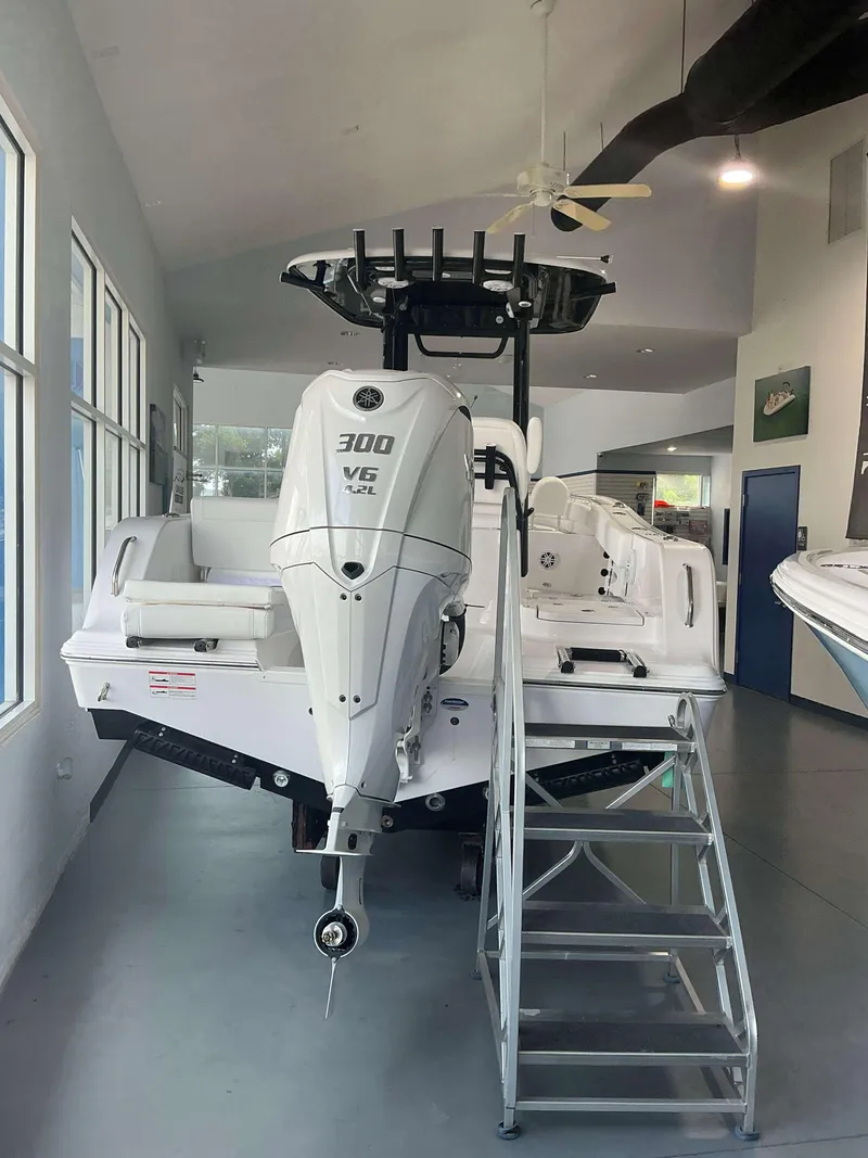 Slide: The Image of 2025 Sportsman 231 Heritage boat with Yamaha 300 V6 engine displayed indoors. - 3