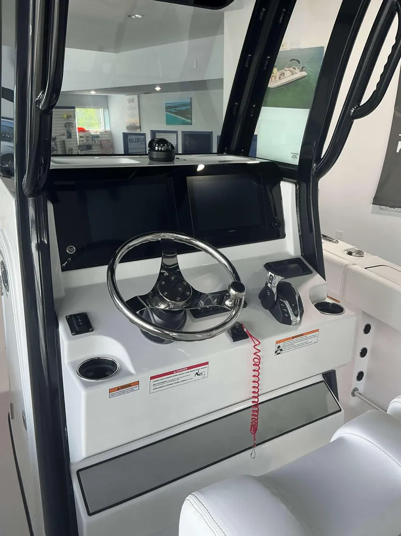 Slide: The Image of 2025 Sportsman 231 Heritage boat dashboard with steering wheel and controls. - 4