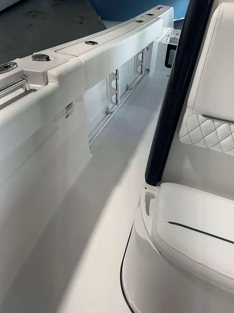 Slide: The Image of 2025 Sportsman 231 Heritage boat interior with white seating and sleek design. - 8