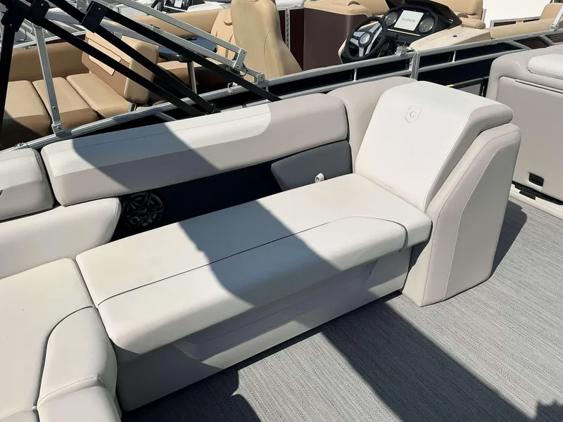 Slide: The Image of 2025 Sweetwater 2286 C boat interior with beige seating and steering wheel. - 15