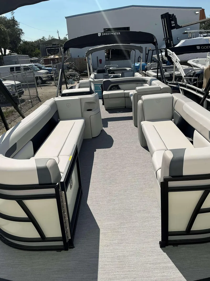 Slide: The Image of 2025 Sweetwater 2286 C pontoon boat with spacious seating and modern design. - 2