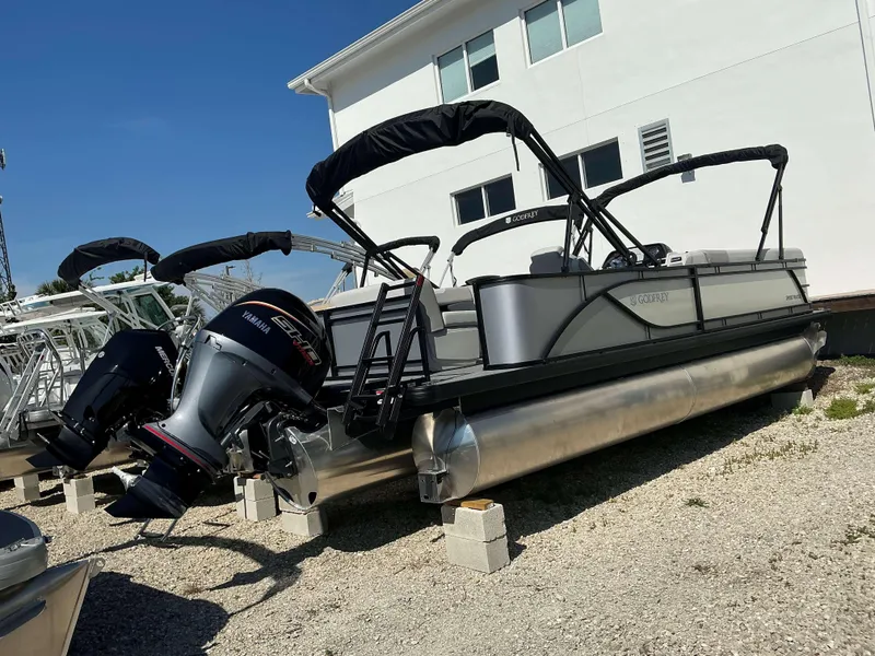 Slide: The Image of 2025 Sweetwater 2286 C pontoon boat with Yamaha engine, parked on gravel. - 4