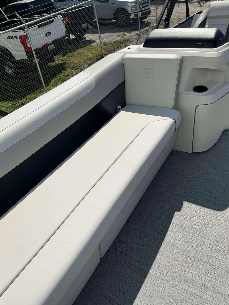 Slide: The Image of 2025 Sweetwater 2286 C boat interior with white seating and cup holder. - 7