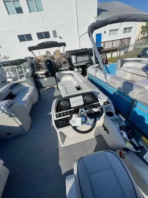 Slide: The Image of 2025 Sweetwater 2286 FS boat interior with modern helm and seating. - 5