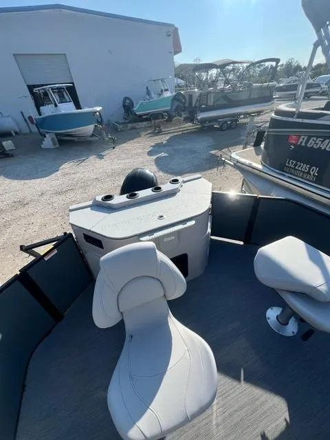 Slide: The Image of 2025 Sweetwater 2286 FS boat interior with white seating and control panel. - 9