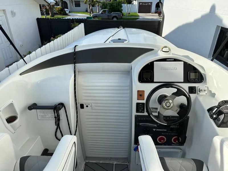 Slide: The Image of 2014 Pronautica 33 Sport 1000 boat cockpit with steering wheel and controls. - 3