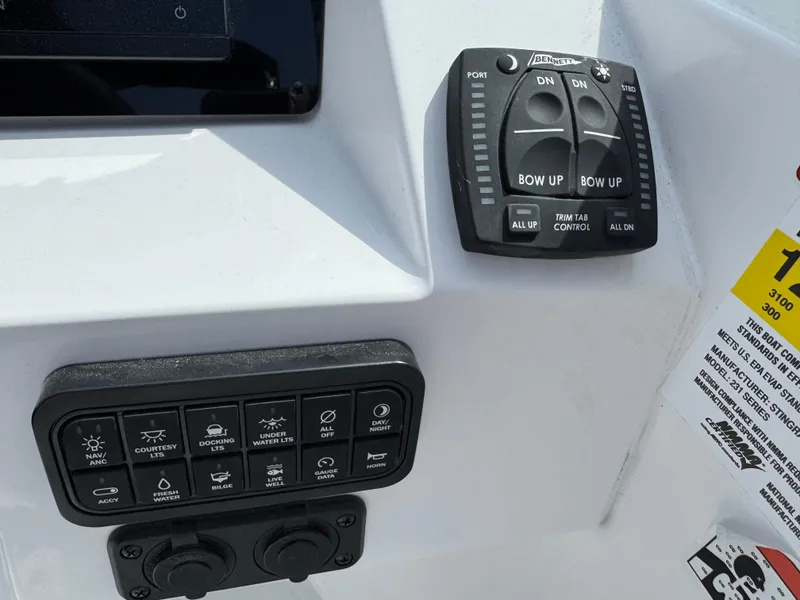 Slide: The Image of Control panel of 2025 Stingray 231 DC boat with various switches and indicators. - 10