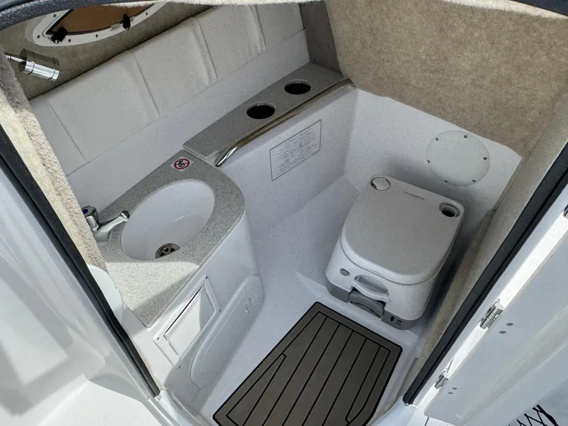 Slide: The Image of 2025 Stingray 231 DC boat interior with sink and portable toilet. - 12