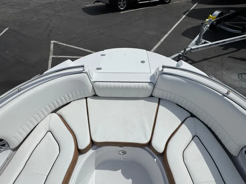 Slide: The Image of 2025 Stingray 231 DC boat interior with white cushioned seating and sleek design. - 17