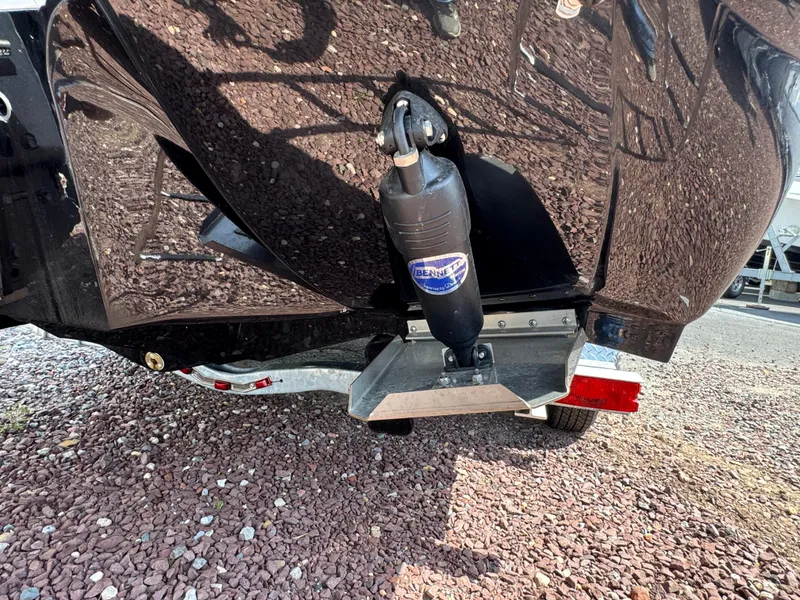 Slide: The Image of 2025 Stingray 231 DC boat hull and propeller detail on gravel surface. - 21