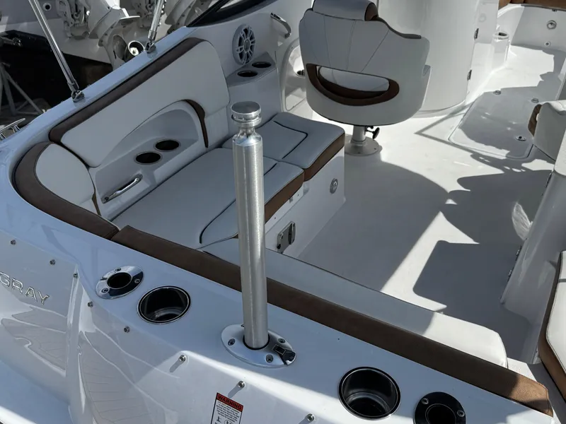 Slide: The Image of 2025 Stingray 231 DC boat interior with white seating and cup holders. - 22
