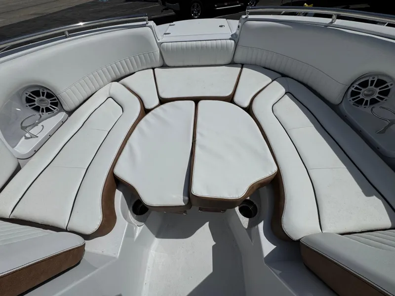 Slide: The Image of 2025 Stingray 231 DC boat interior with white cushioned seating and integrated speakers. - 23