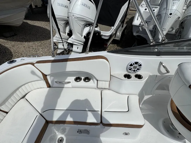 Slide: The Image of 2025 Stingray 231 DC boat interior with white seating and Yamaha outboard motors. - 4