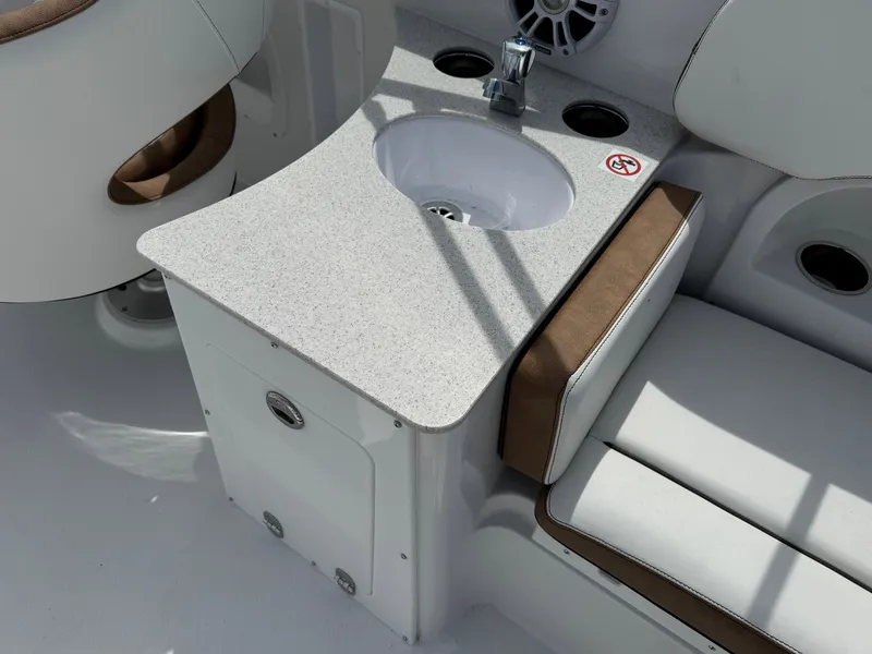 Slide: The Image of 2025 Stingray 231 DC boat interior with sink and seating area. - 5