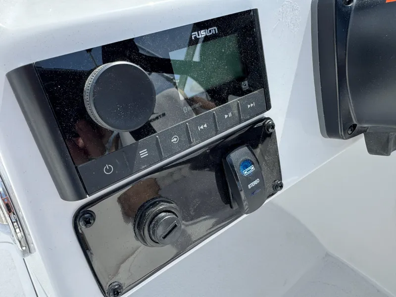 Slide: The Image of Control panel of 2025 Stingray 231 DC boat featuring Fusion audio system. - 9