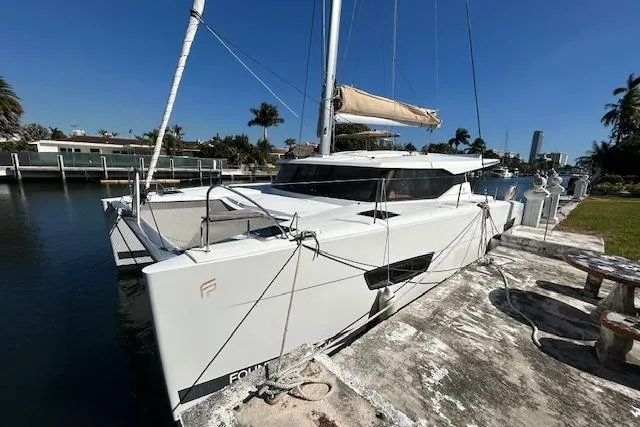 The Image of 2019 Fountaine Pajot Lucia 40 catamaran docked in a sunny marina. - 0