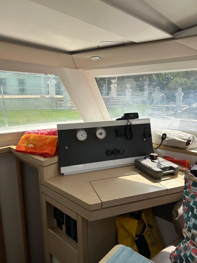 Slide: The Image of Interior of 2019 Fountaine Pajot Lucia 40 catamaran with navigation instruments and bright natural light. - 11