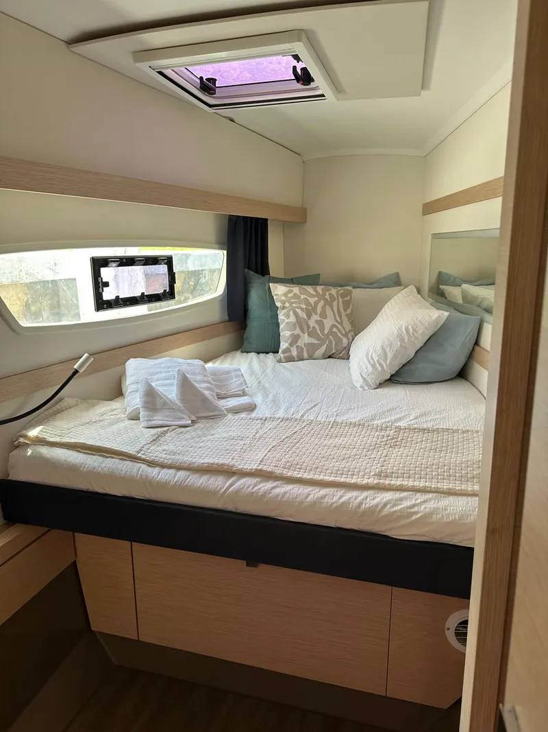 Slide: The Image of Cozy cabin interior of 2019 Fountaine Pajot Lucia 40 catamaran with bed and window. - 12