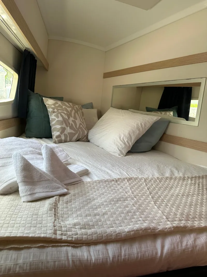 Slide: The Image of Cozy cabin interior of 2019 Fountaine Pajot Lucia 40 with plush bedding and elegant decor. - 13