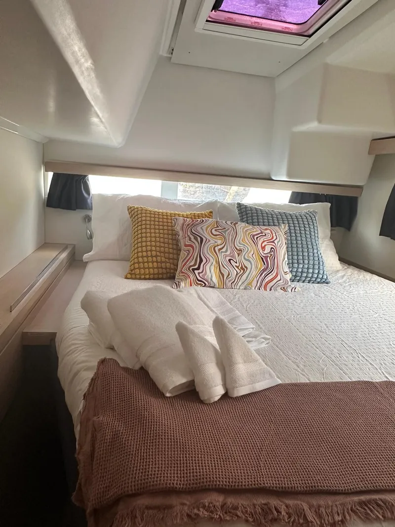 Slide: The Image of Cozy cabin interior of 2019 Fountaine Pajot Lucia 40 with colorful pillows and soft linens. - 15
