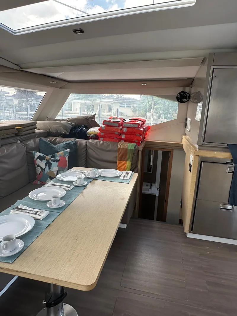 Slide: The Image of Interior of 2019 Fountaine Pajot Lucia 40 catamaran with dining table and seating area. - 16