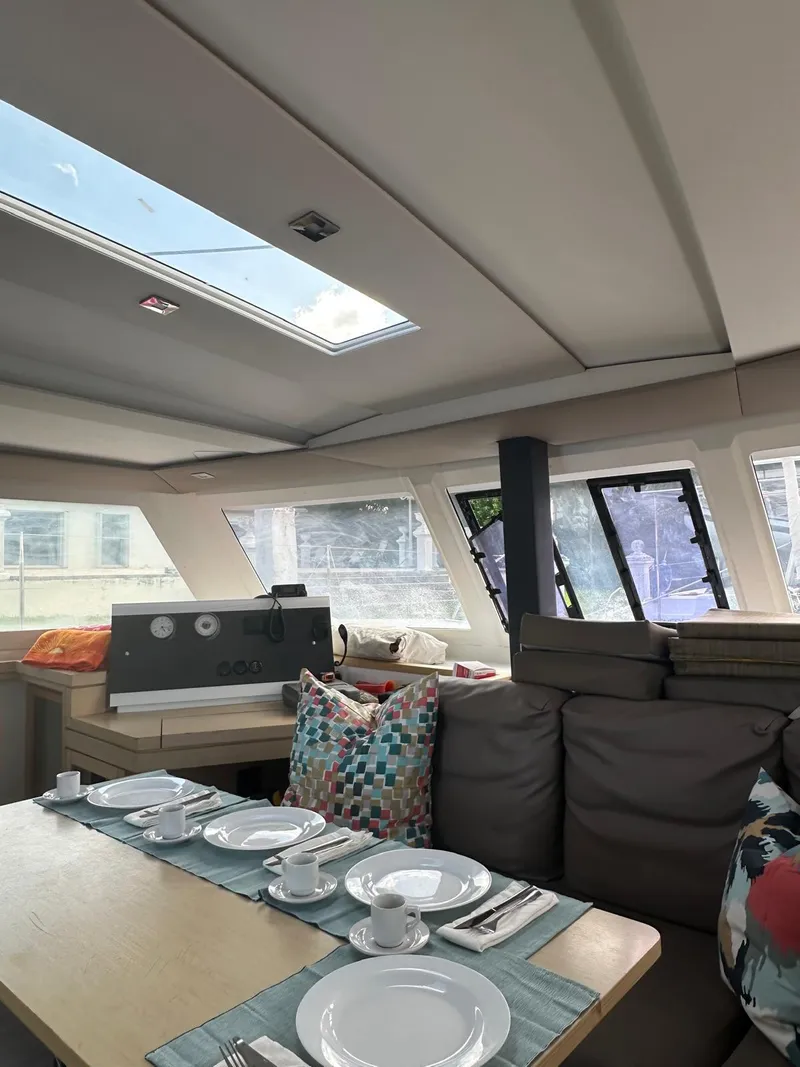 Slide: The Image of Interior of 2019 Fountaine Pajot Lucia 40 catamaran with dining setup and skylight. - 17