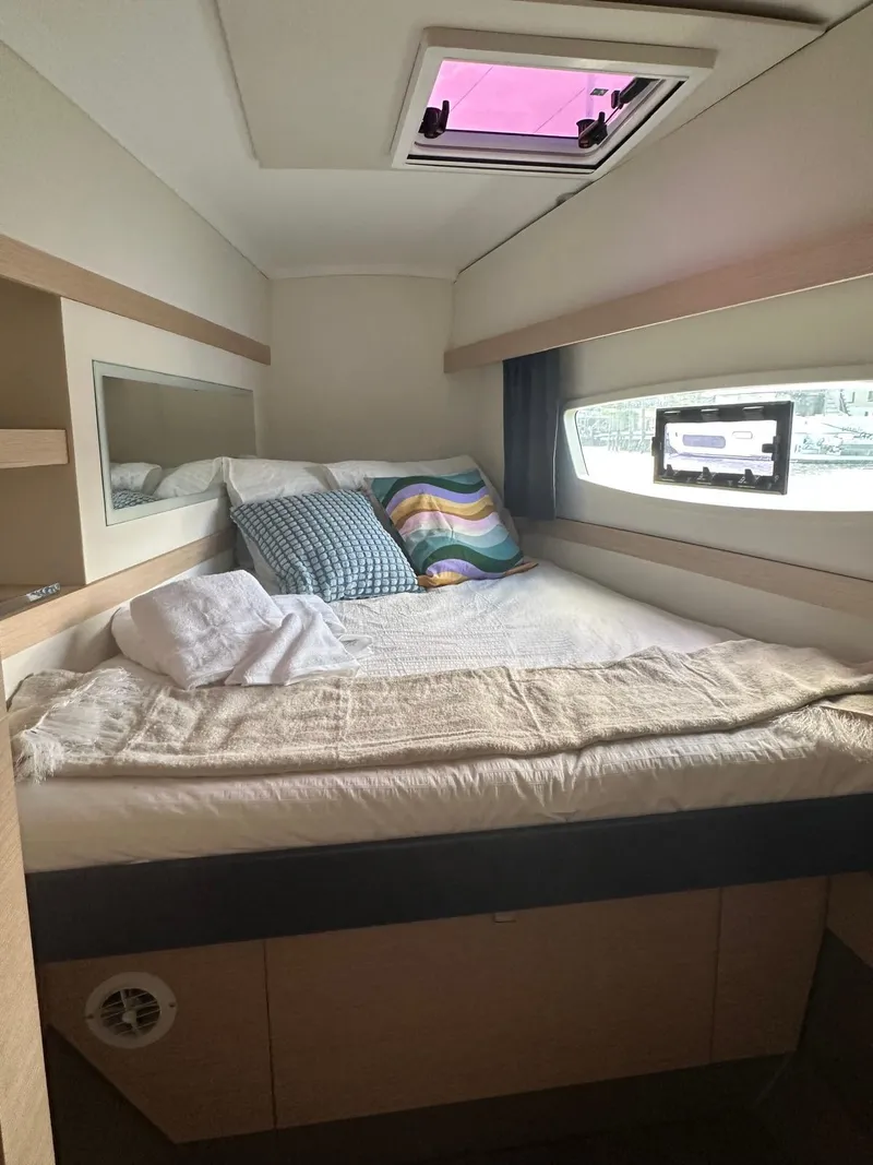 Slide: The Image of Cozy cabin interior of 2019 Fountaine Pajot Lucia 40 catamaran with bed and window view. - 18