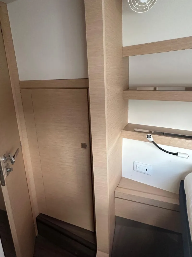 Slide: The Image of Interior of 2019 Fountaine Pajot Lucia 40 yacht with wooden shelves and modern design. - 19