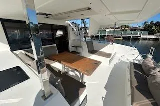 Slide: The Image of 2019 Fountaine Pajot Lucia 40 catamaran with spacious outdoor seating and dining area. - 2