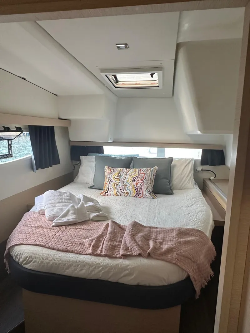 Slide: The Image of Cozy bedroom interior of 2019 Fountaine Pajot Lucia 40 catamaran with skylight and plush bedding. - 20