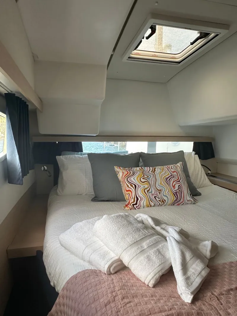 Slide: The Image of Cozy cabin interior of 2019 Fountaine Pajot Lucia 40 with skylight and colorful pillow. - 21