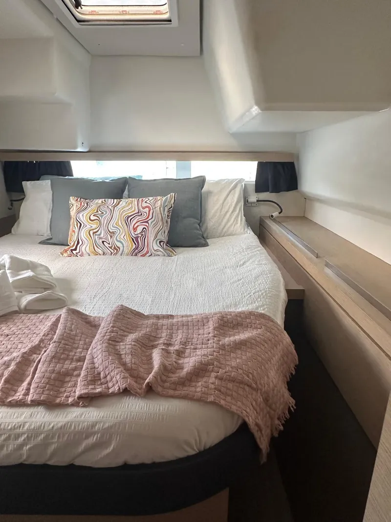 Slide: The Image of Cozy bedroom in 2019 Fountaine Pajot Lucia 40 catamaran with stylish bedding and natural light. - 22