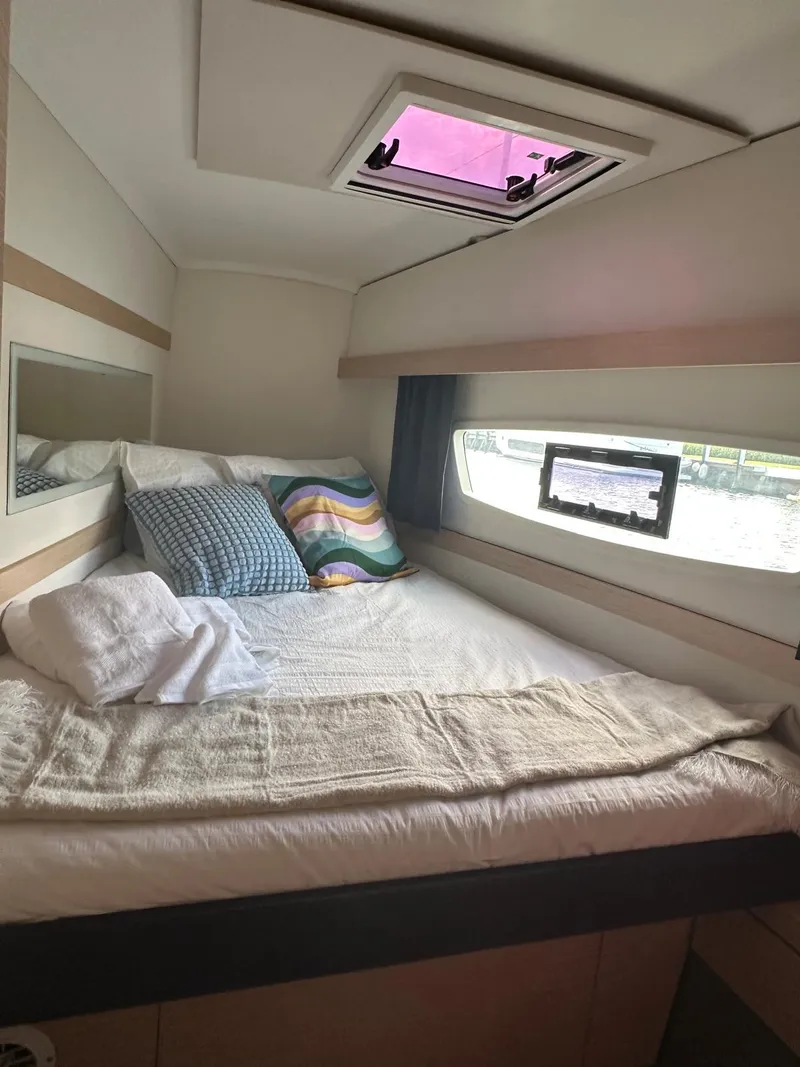 Slide: The Image of Cozy cabin interior of 2019 Fountaine Pajot Lucia 40 catamaran with bed and window view. - 26
