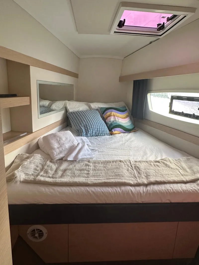 Slide: The Image of Cozy cabin interior of 2019 Fountaine Pajot Lucia 40 catamaran with bed and window view. - 28