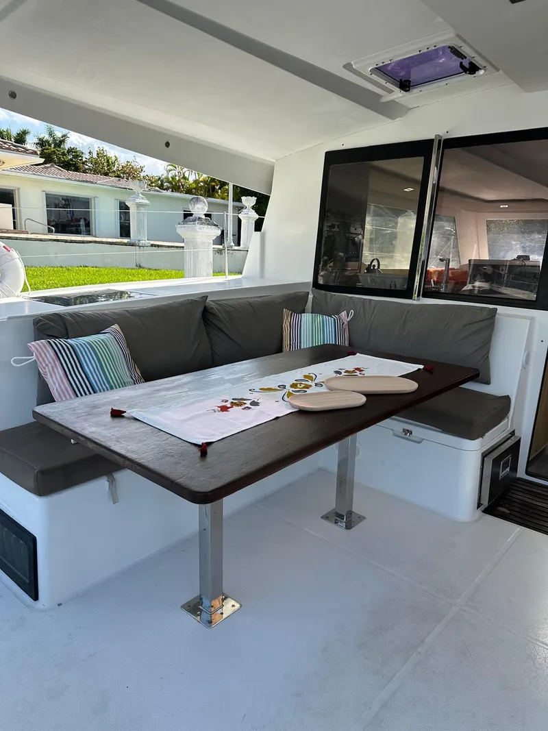 Slide: The Image of 2019 Fountaine Pajot Lucia 40 yacht interior with dining area and cushioned seating. - 29