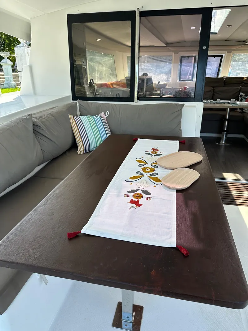 Slide: The Image of Cozy seating area on 2019 Fountaine Pajot Lucia 40 catamaran with decorative table runner. - 30
